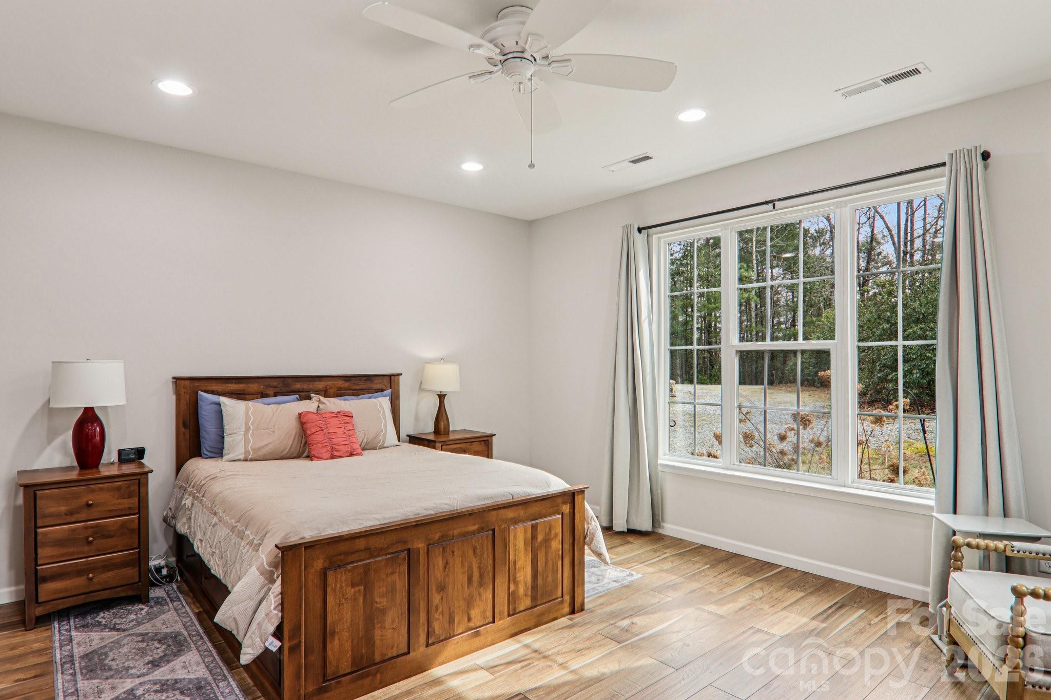 29 Saddle Top Road Flat Rock, NC 28731 - Photo 25 of 46 a spacious bedroom with a large bed and a large window
