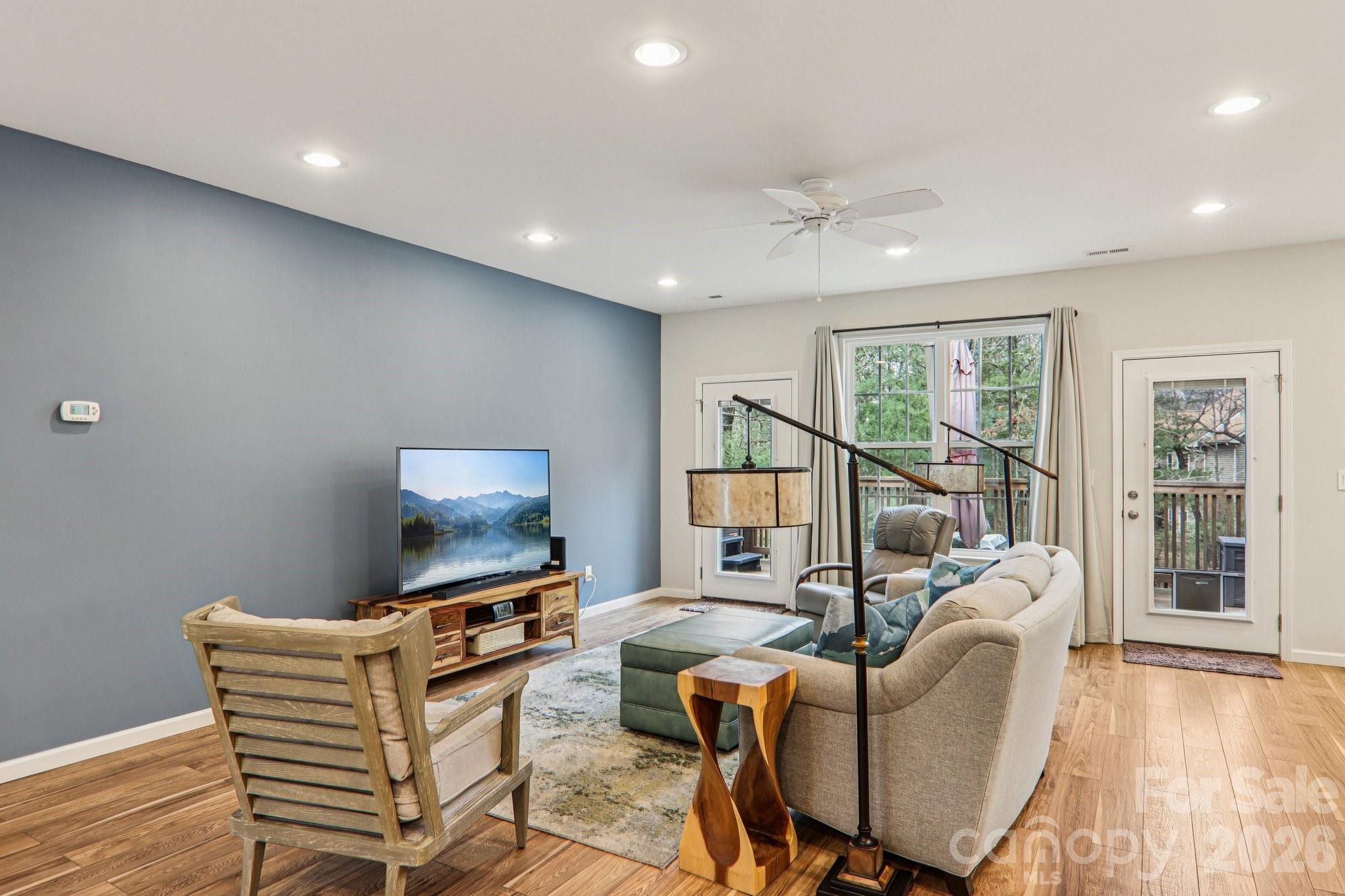29 Saddle Top Road Flat Rock, NC 28731 - Photo 6 of 46 a living room with furniture and a flat screen tv