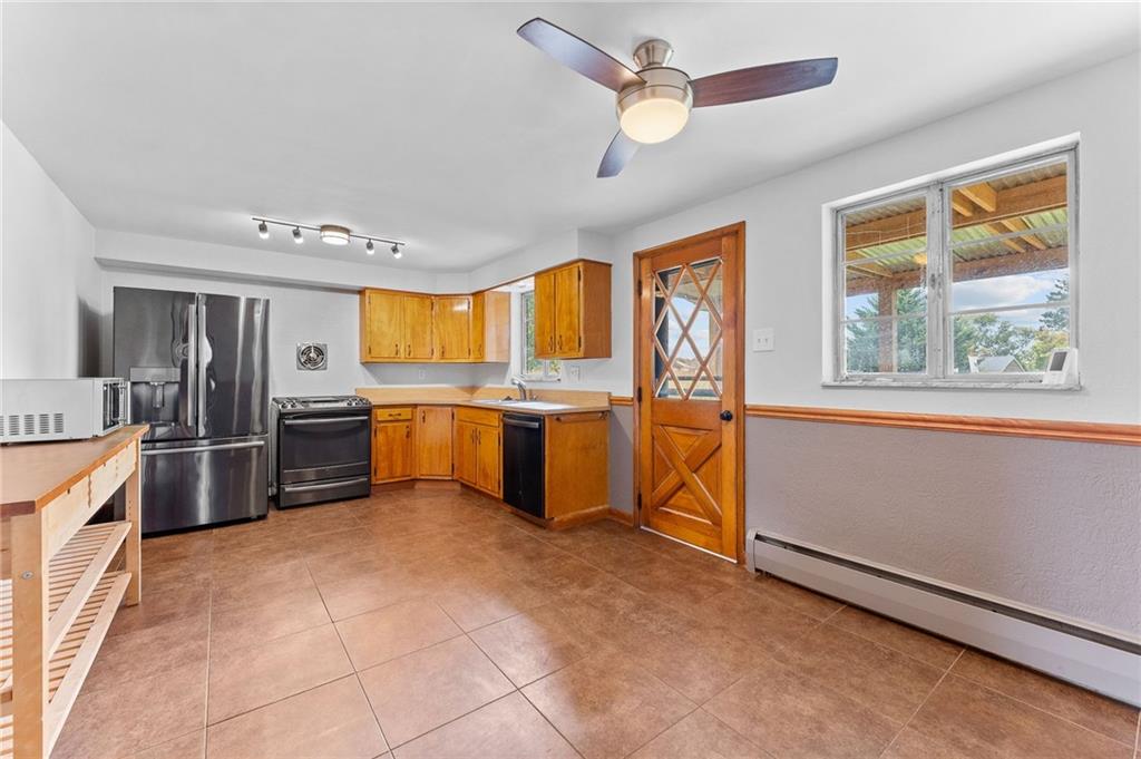 409 4th Street McDonald, PA 15057 - Photo 12 of 37 a large kitchen with stainless steel appliances a stove a refrigerator and a sink