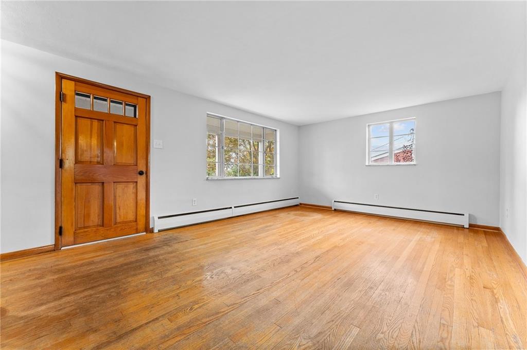 409 4th Street McDonald, PA 15057 - Photo 6 of 37 a view of an empty room with wooden floor and a window