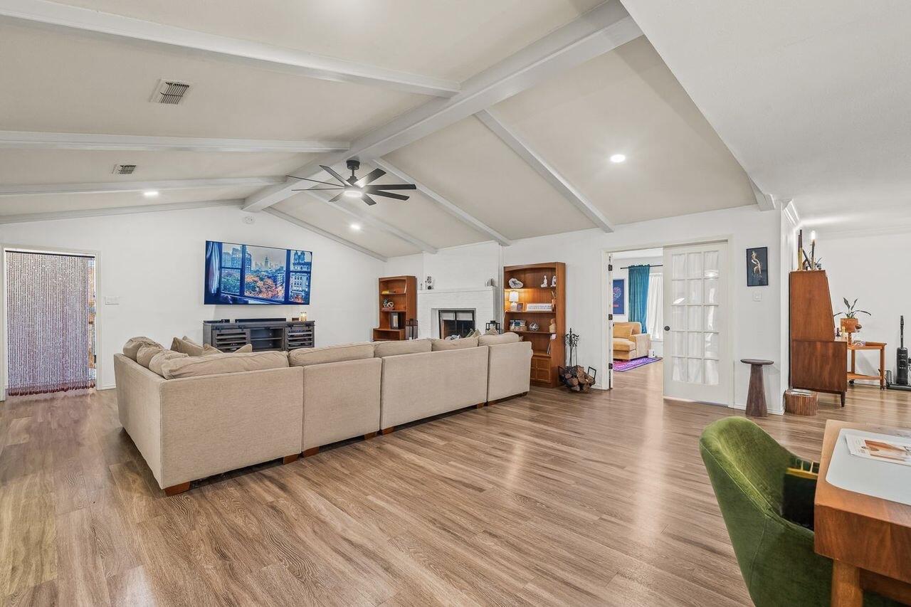 3410 94th Street Lubbock, TX 79423 - Photo 12 of 57 a living room with furniture and a wooden floor