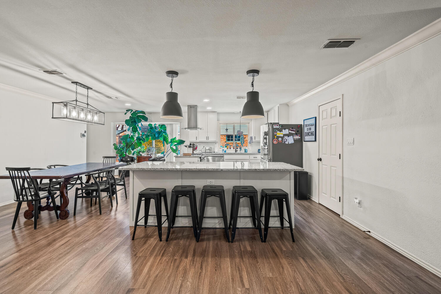 3410 94th Street Lubbock, TX 79423 - Photo 14 of 57 a view of a dining room with furniture and wooden floor