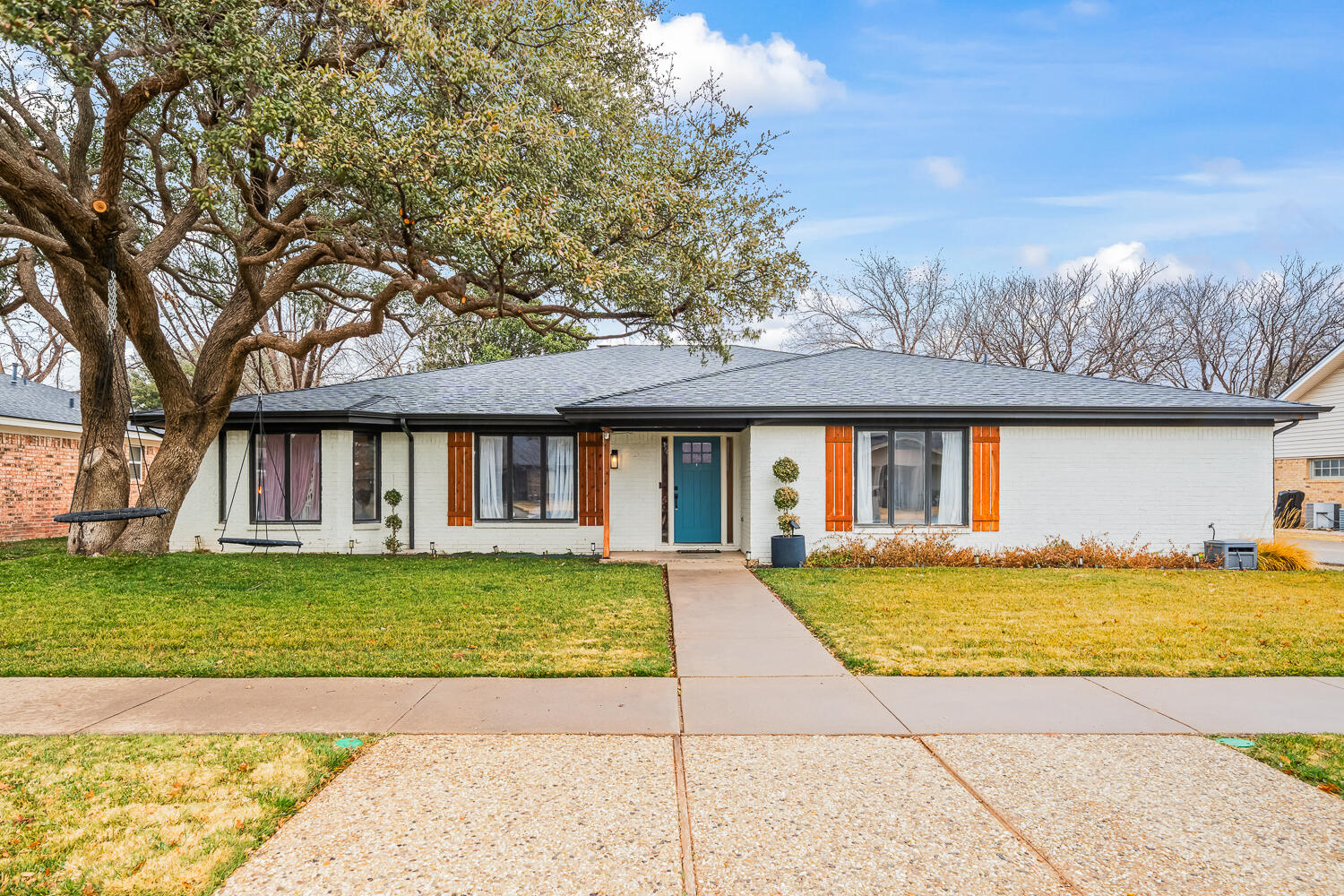 3410 94th Street Lubbock, TX 79423 - Photo 2 of 57 a view of a house with a swimming pool and a yard