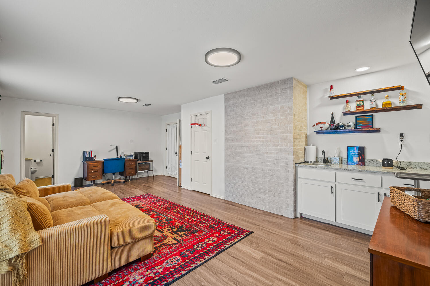 3410 94th Street Lubbock, TX 79423 - Photo 28 of 57 a living room with furniture and a wooden floor