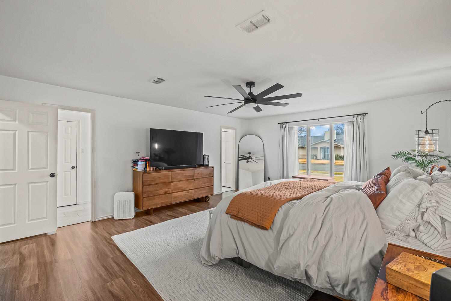 3410 94th Street Lubbock, TX 79423 - Photo 33 of 57 a bedroom with a bed and a flat screen tv