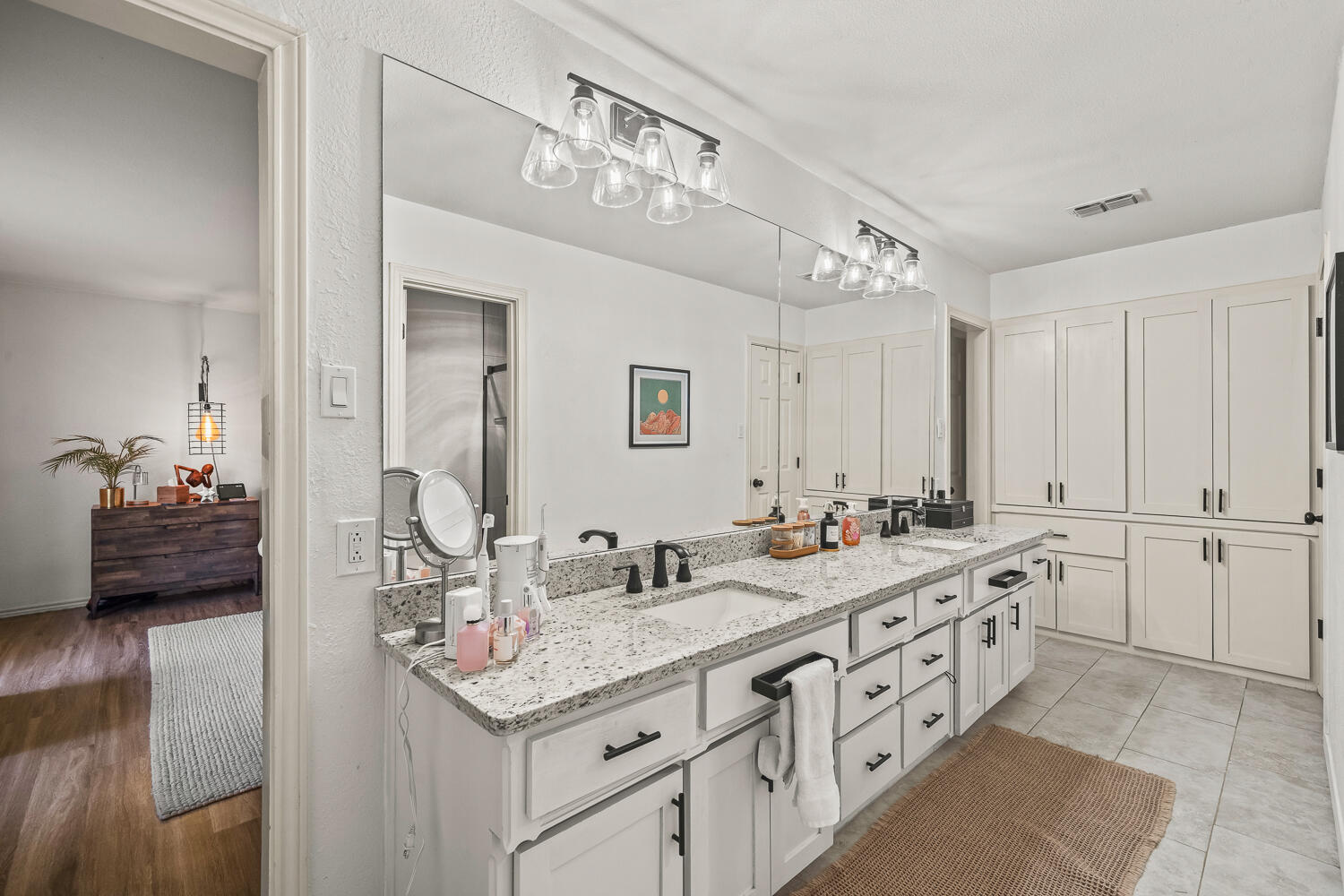 3410 94th Street Lubbock, TX 79423 - Photo 36 of 57 a bathroom with a double vanity sink and a mirror
