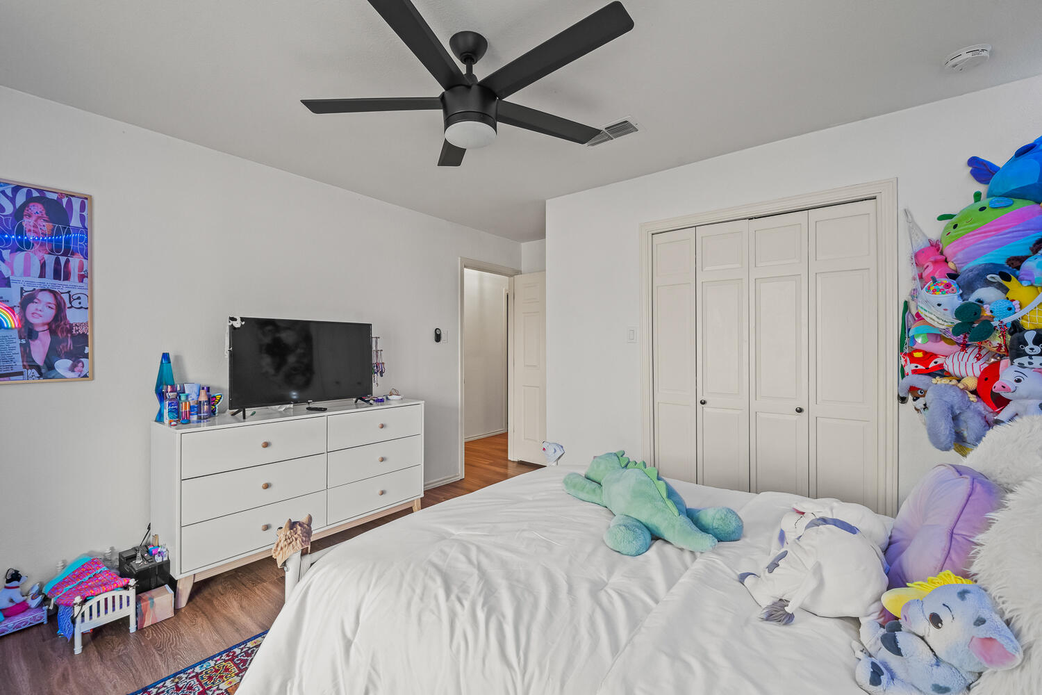 3410 94th Street Lubbock, TX 79423 - Photo 49 of 57 a bedroom with a bed and flat screen tv