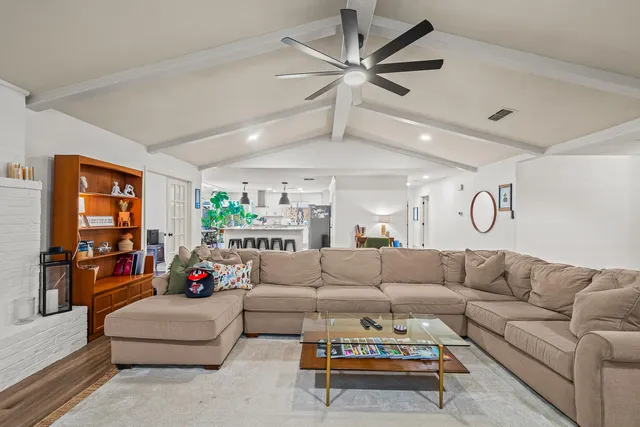 a living room with furniture ceiling fan and a rug