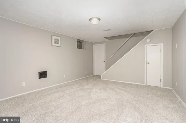 a view of an empty room with stairs