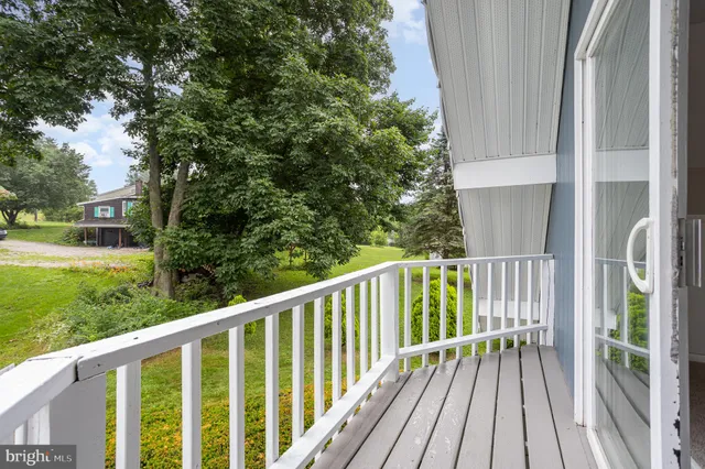 a view of a balcony with wooden floor