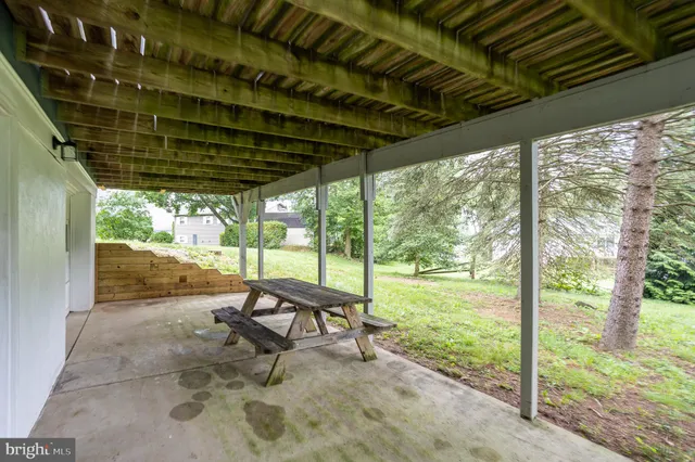 a view of a porch with chairs and backyard