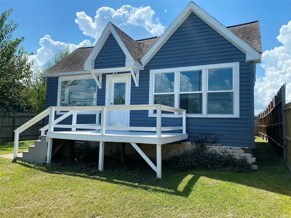 a front view of a house with a yard table and chairs