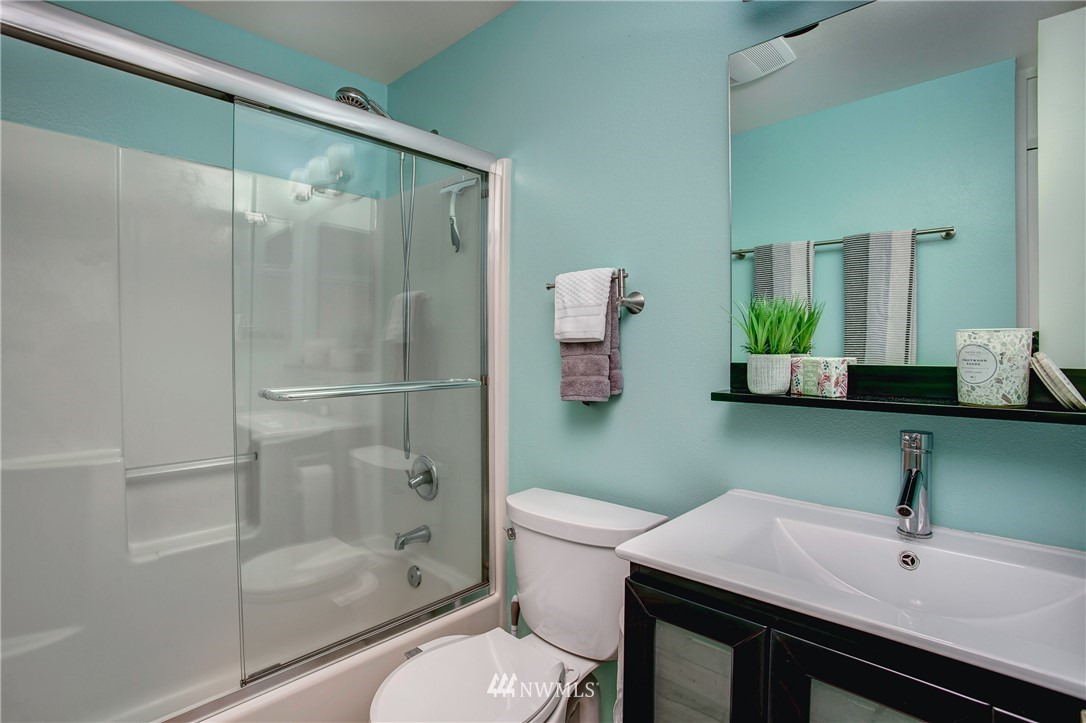 2400 East Howell Street, Unit E Seattle, WA 98122 - Photo 18 of 39 a bathroom with a sink and a mirror