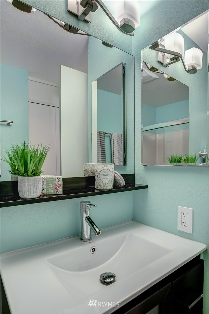 2400 East Howell Street, Unit E Seattle, WA 98122 - Photo 19 of 39 a bathroom with a sink and a mirror