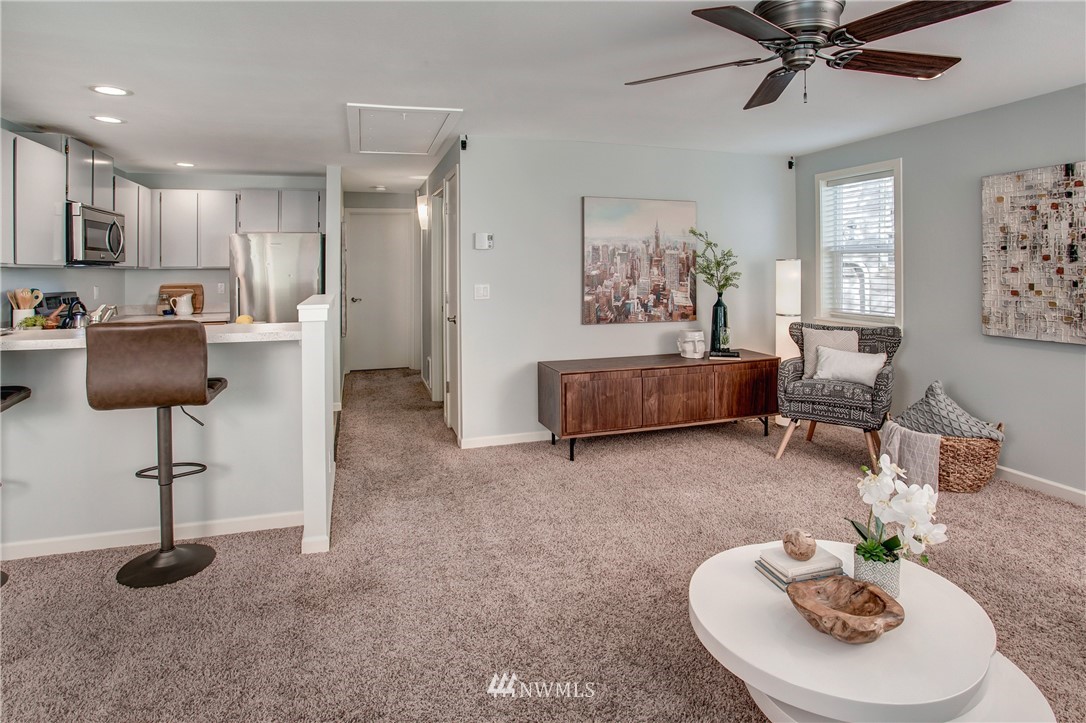 2400 East Howell Street, Unit E Seattle, WA 98122 - Photo 7 of 39 a living room with furniture and a chandelier
