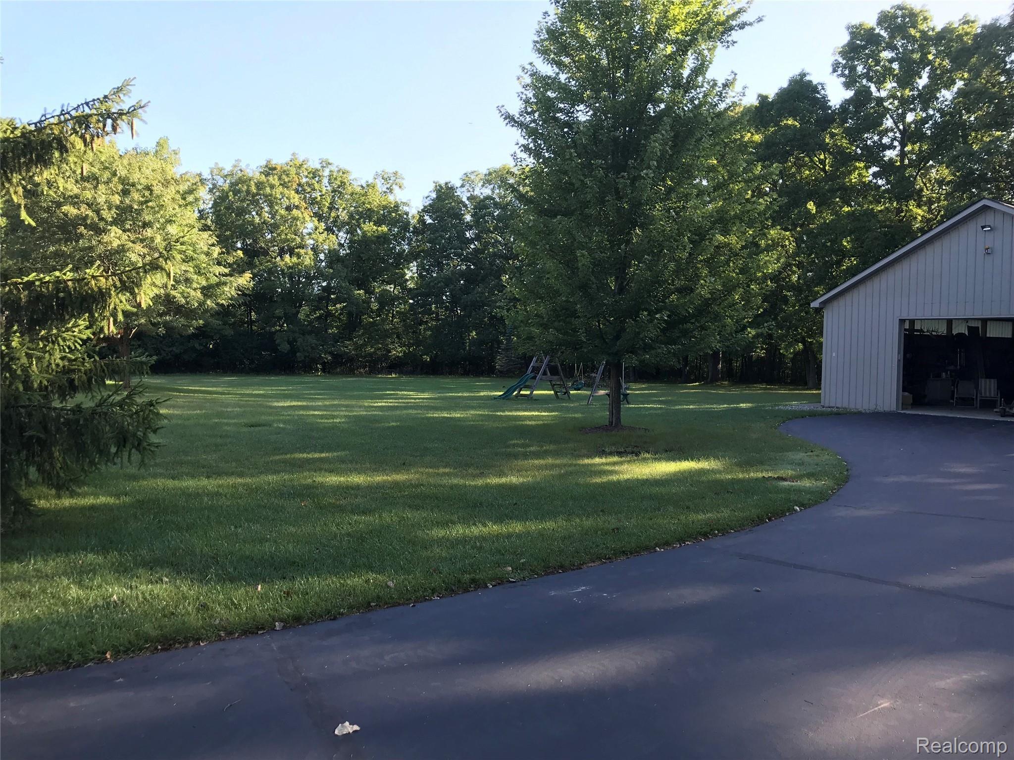 7296 Nollar Road Whitmore Lake, MI 48189 - Photo 26 of 55 PARTIAL BACK YARD BEFORE THE WOODS