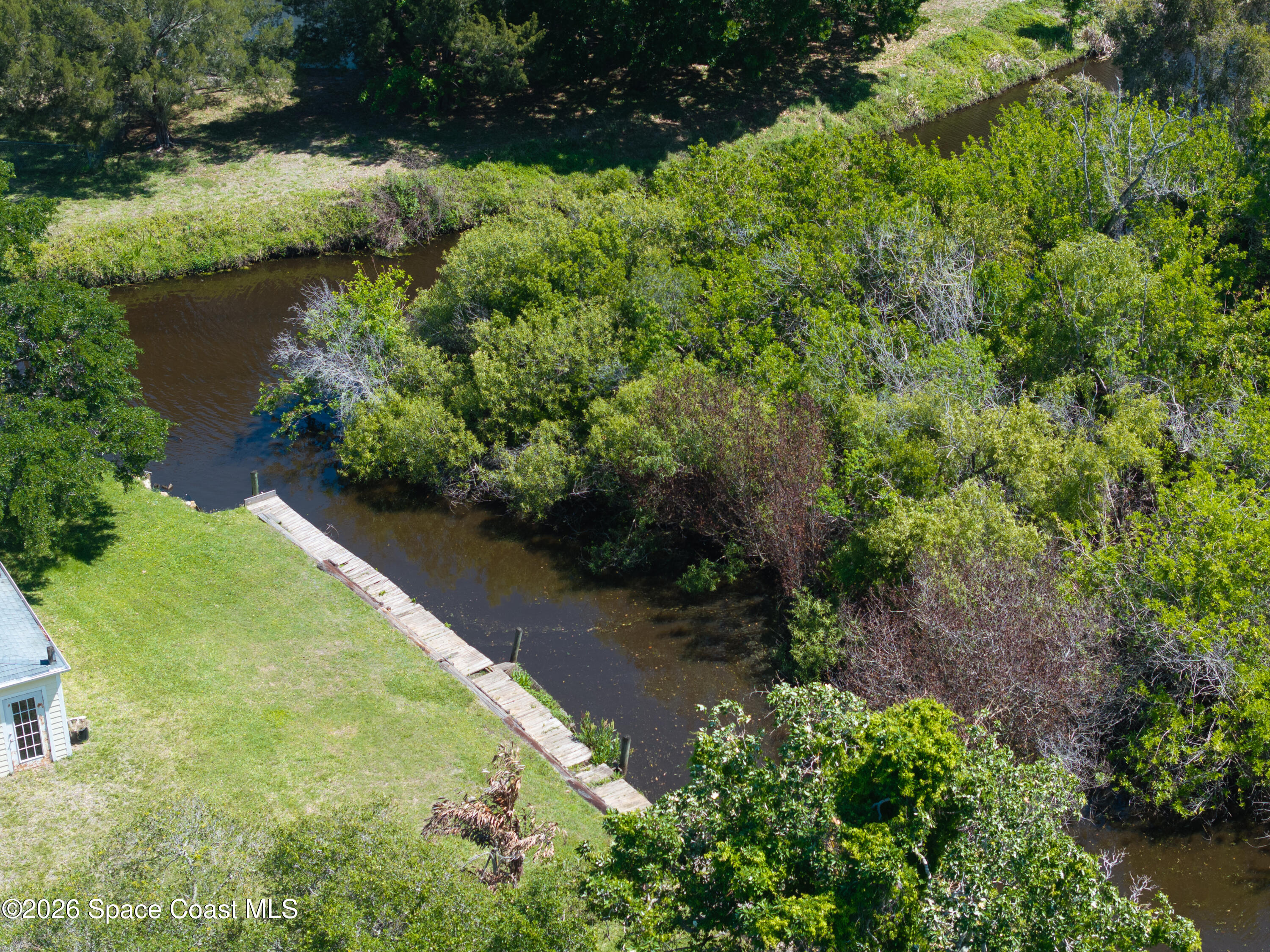 684 Rear N Harbor Drive Melbourne, FL 32935 - Photo 11 of 11 a view of a garden with a lake