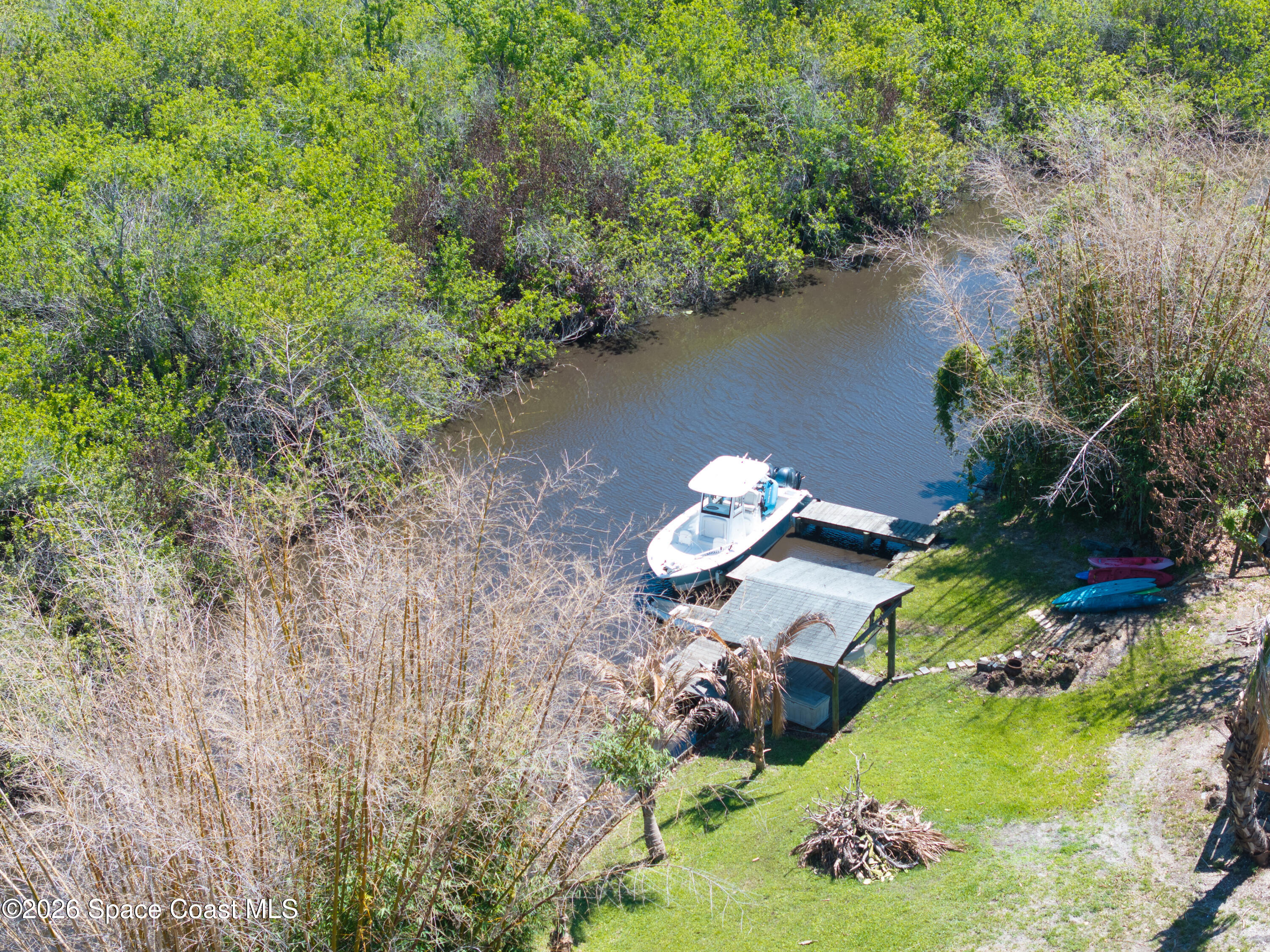 684 Rear N Harbor Drive Melbourne, FL 32935 - Photo 9 of 11 an aerial view of a house with a yard and lake view