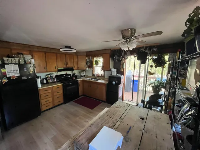 a kitchen with a refrigerator a stove top oven a sink and dishwasher