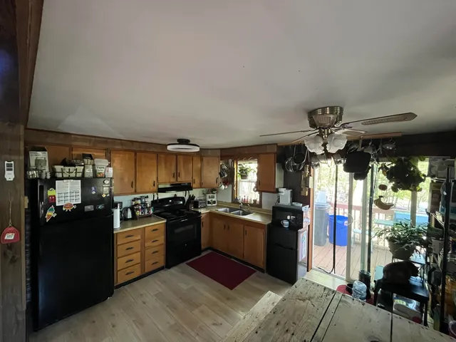a kitchen with stainless steel appliances granite countertop sink stove and refrigerator