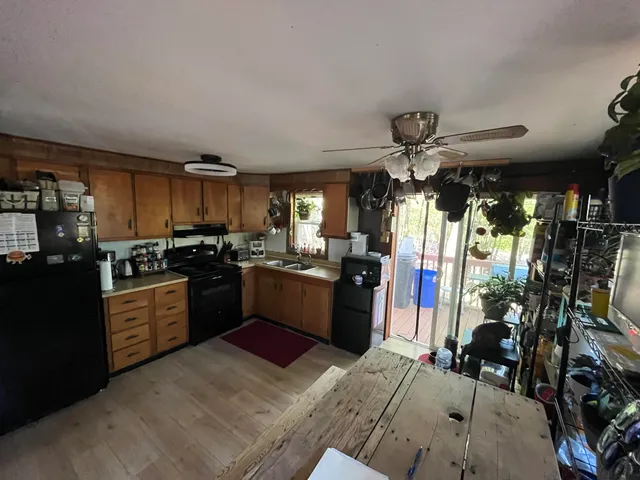 a kitchen with a refrigerator and a sink