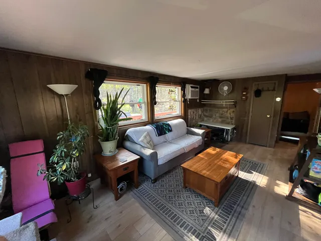 a living room with furniture and a floor to ceiling window