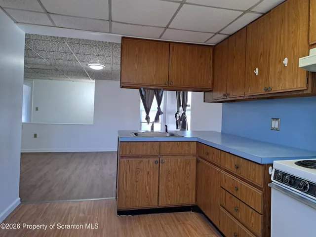 a kitchen with cabinets a sink and appliances