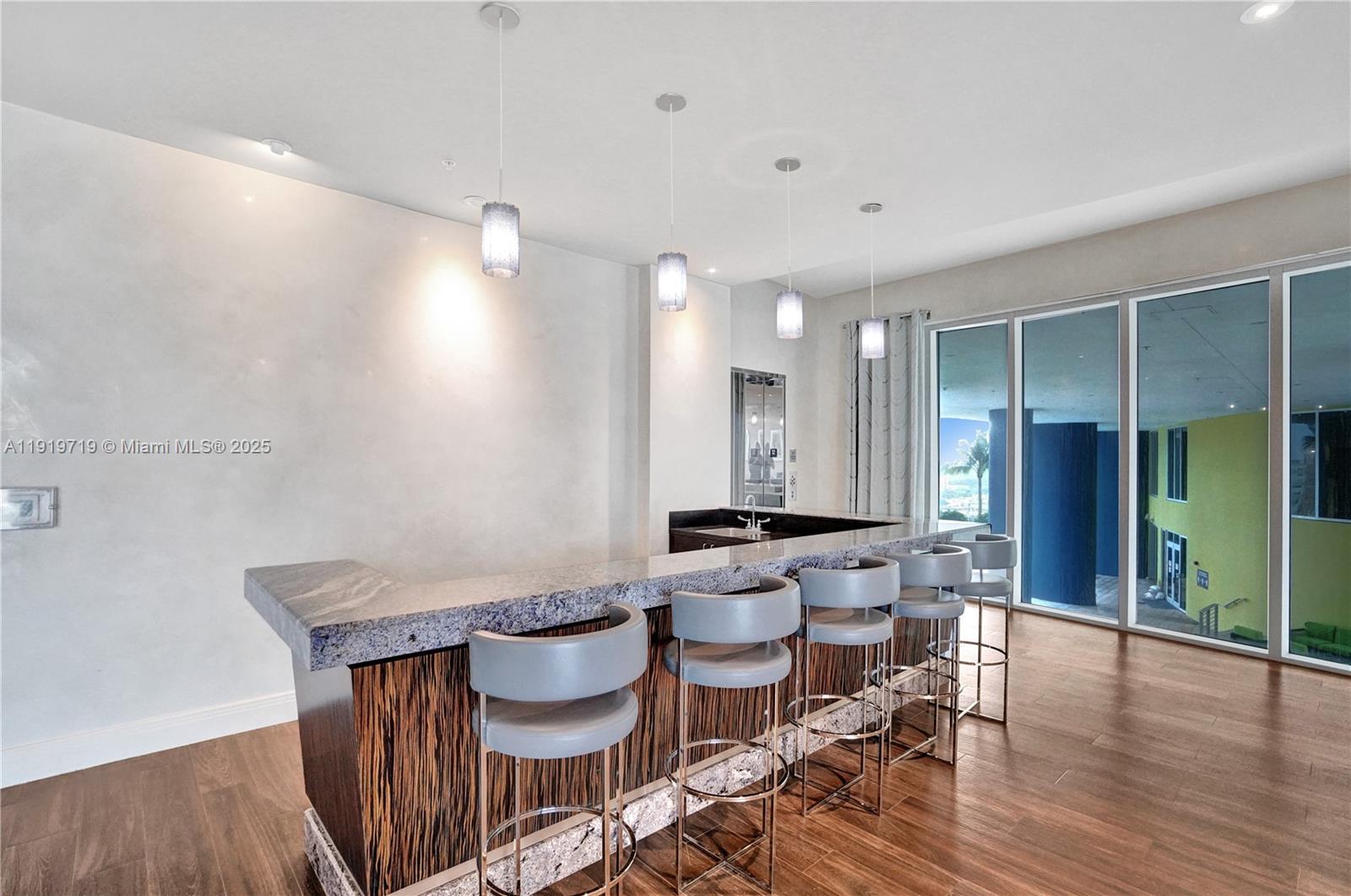 185 Southwest 7th Street, Unit 2011 Miami, FL 33130 - Photo 19 of 30 a view of a dining room with furniture and wooden floor