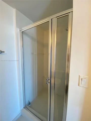 a bathroom with a glass shower door