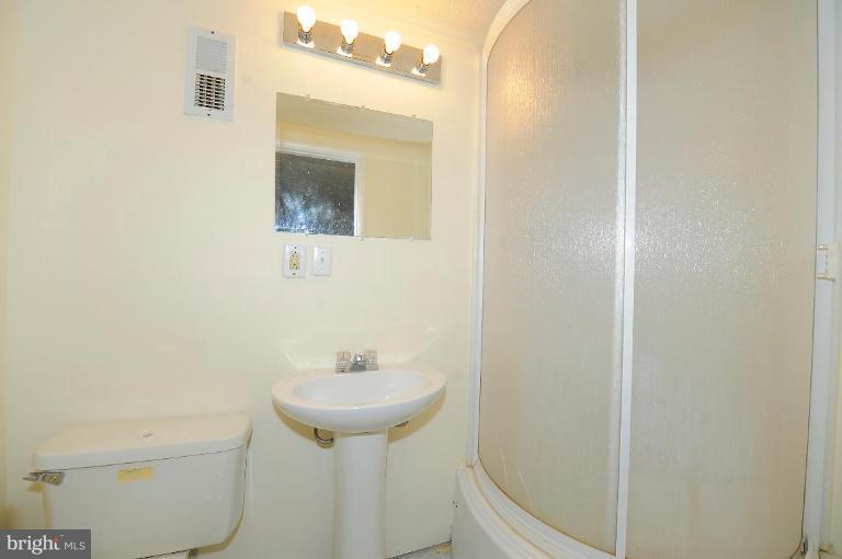 8228 Monaegan Court Severn, MD 21144 - Photo 6 of 9 a bathroom with a sink and mirror with toilet