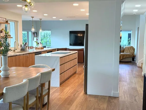 a kitchen with a sink cabinets and wooden floor