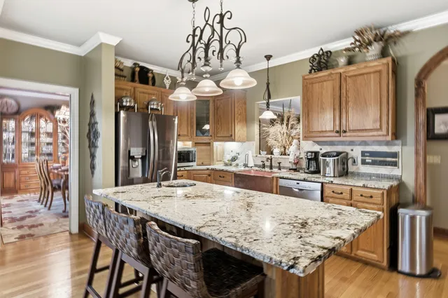 a dining room with furniture a chandelier and wooden floor