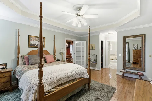 a view of a livingroom with wooden floor and stairs