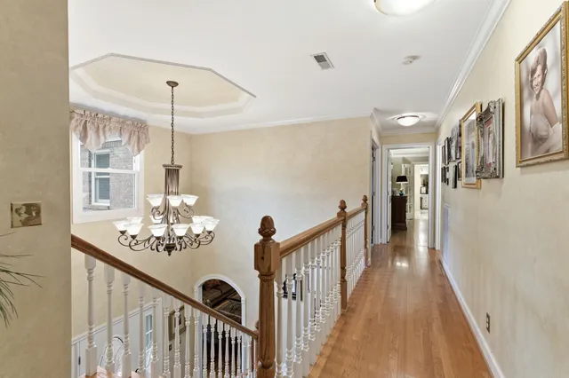 a bed sitting in a room next to a window and a flat screen tv