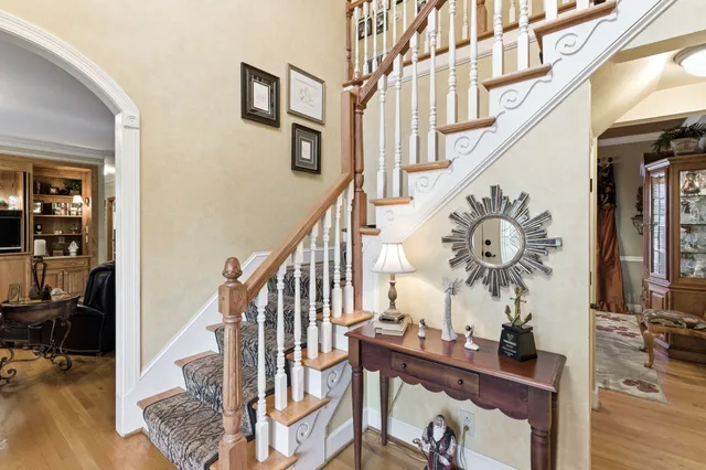 a view of entryway and hall with wooden floor