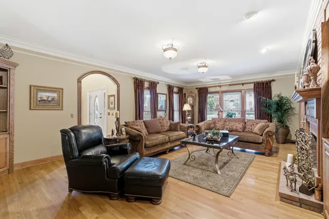 a kitchen with stainless steel appliances granite countertop wooden floor dining table and chairs