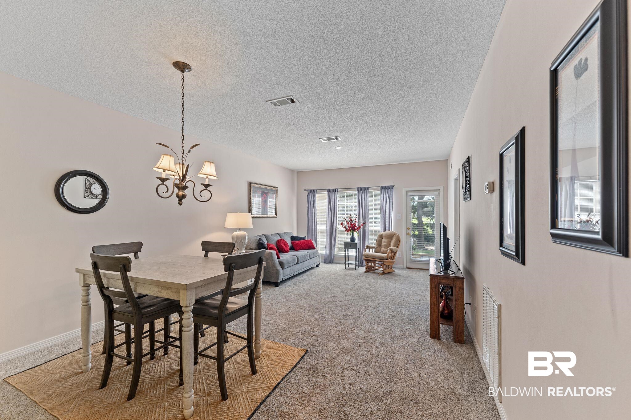 2651 South Juniper Street, Unit 203 Foley, AL 36535 - Photo 6 of 22 Carpeted dining area with a textured ceiling and a chandelier