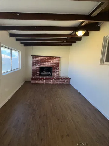 a view of an empty room with a fireplace