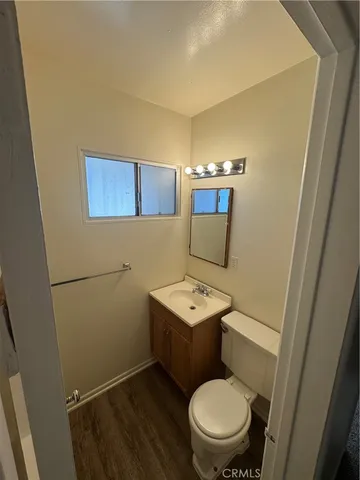 a bathroom with a toilet a sink and a mirror