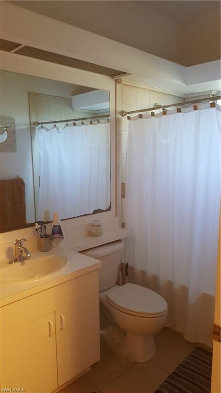 9120 Frank Road Fort Myers, FL 33967 - Photo 6 of 9 a bathroom with a granite countertop sink toilet and a shower