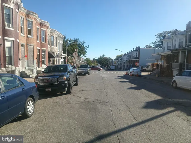 a view of a cars park in front of a building