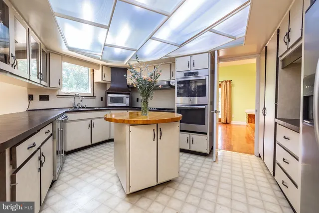 a kitchen with a sink stove and refrigerator