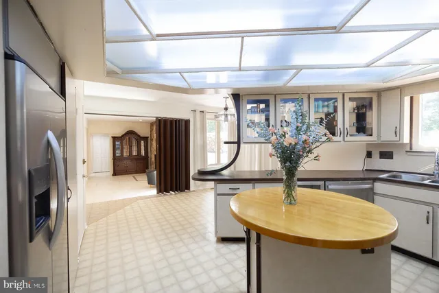 a kitchen with sink stove and cabinets
