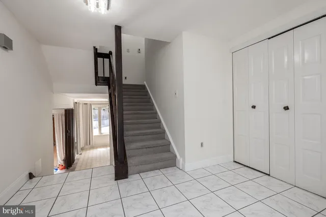 a spacious bedroom with a bed and a lamp