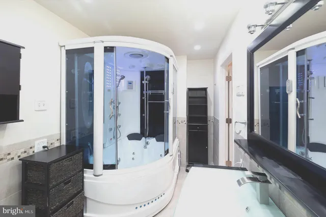 a bathroom with a toilet sink a mirror and shower