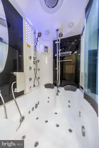 a bathroom with a tub sink and mirror