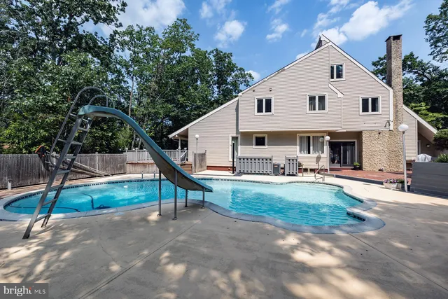 a view of a backyard with swimming pool