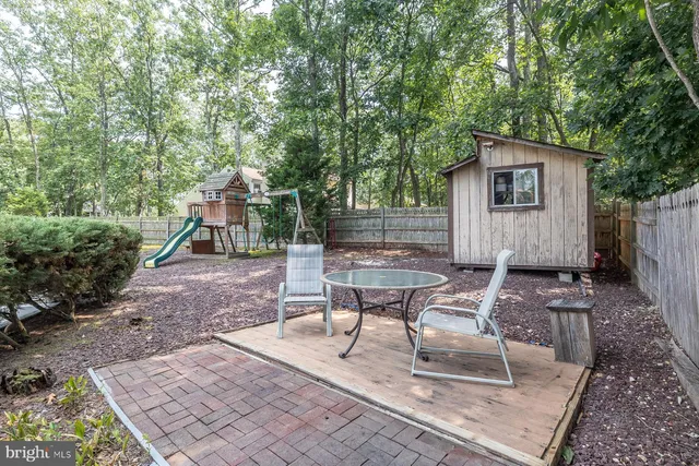 a view of a patio with couches table and chairs and potted plants