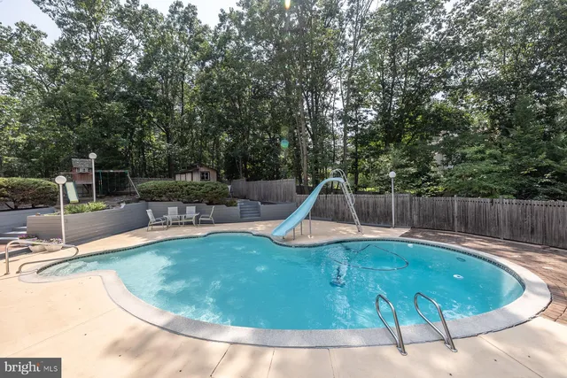 a view of a house with a yard and potted plants