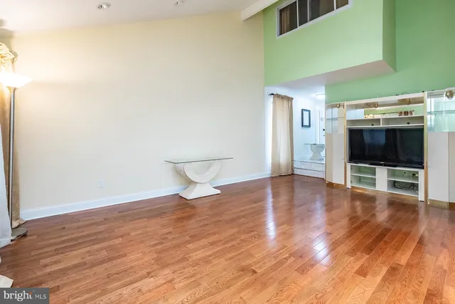 a view of empty room with wooden floor